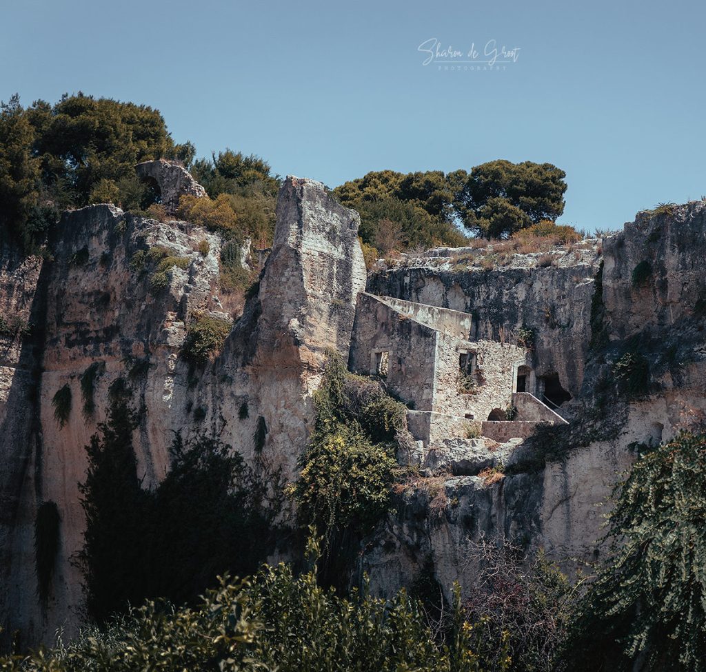 Ruin of a building perched upon a cliff.